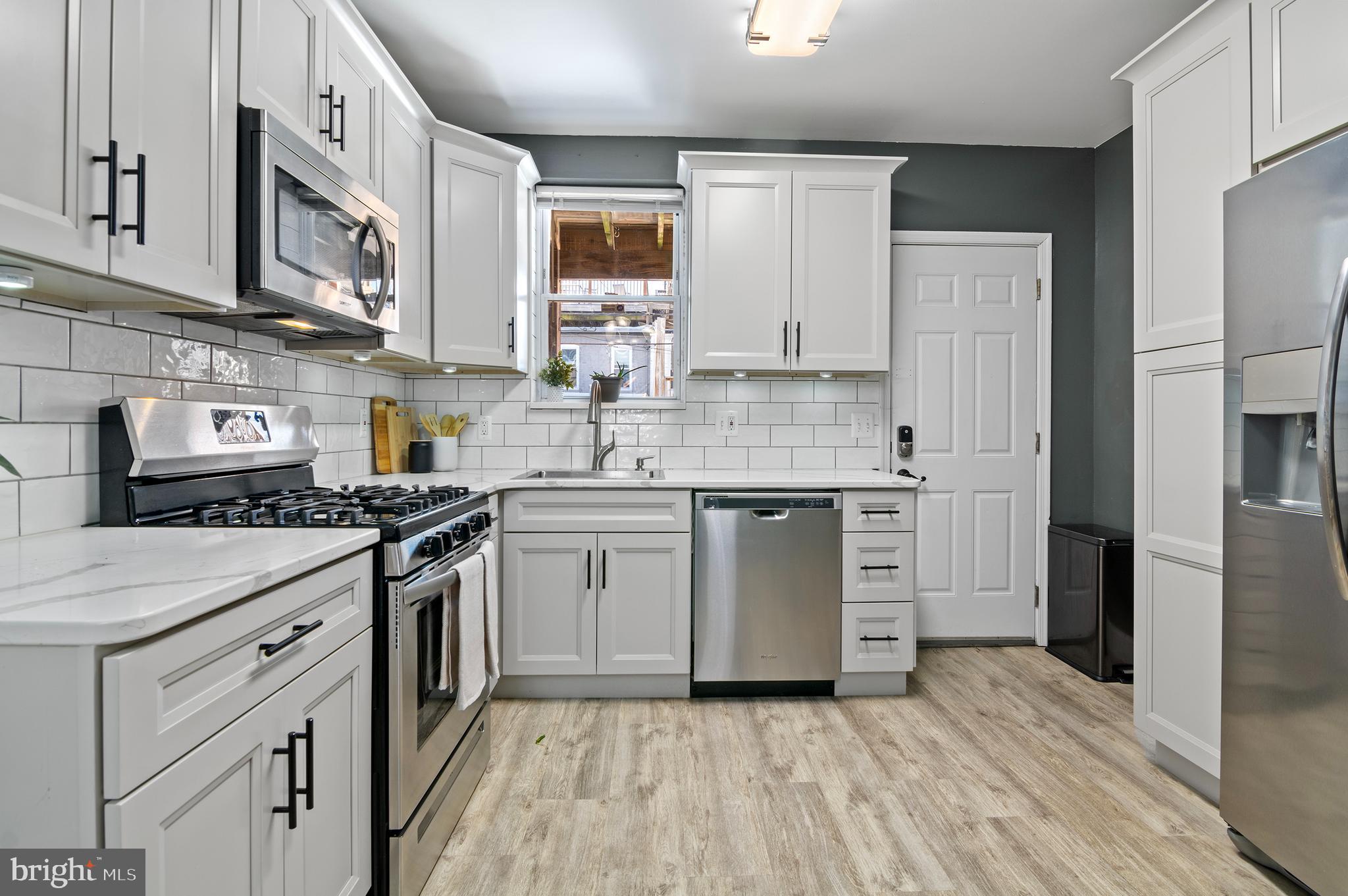 416 South Bouldin Street Baltimore, MD 21224 - Photo 20 of 45 a kitchen with stainless steel appliances cabinets a sink and a stove
