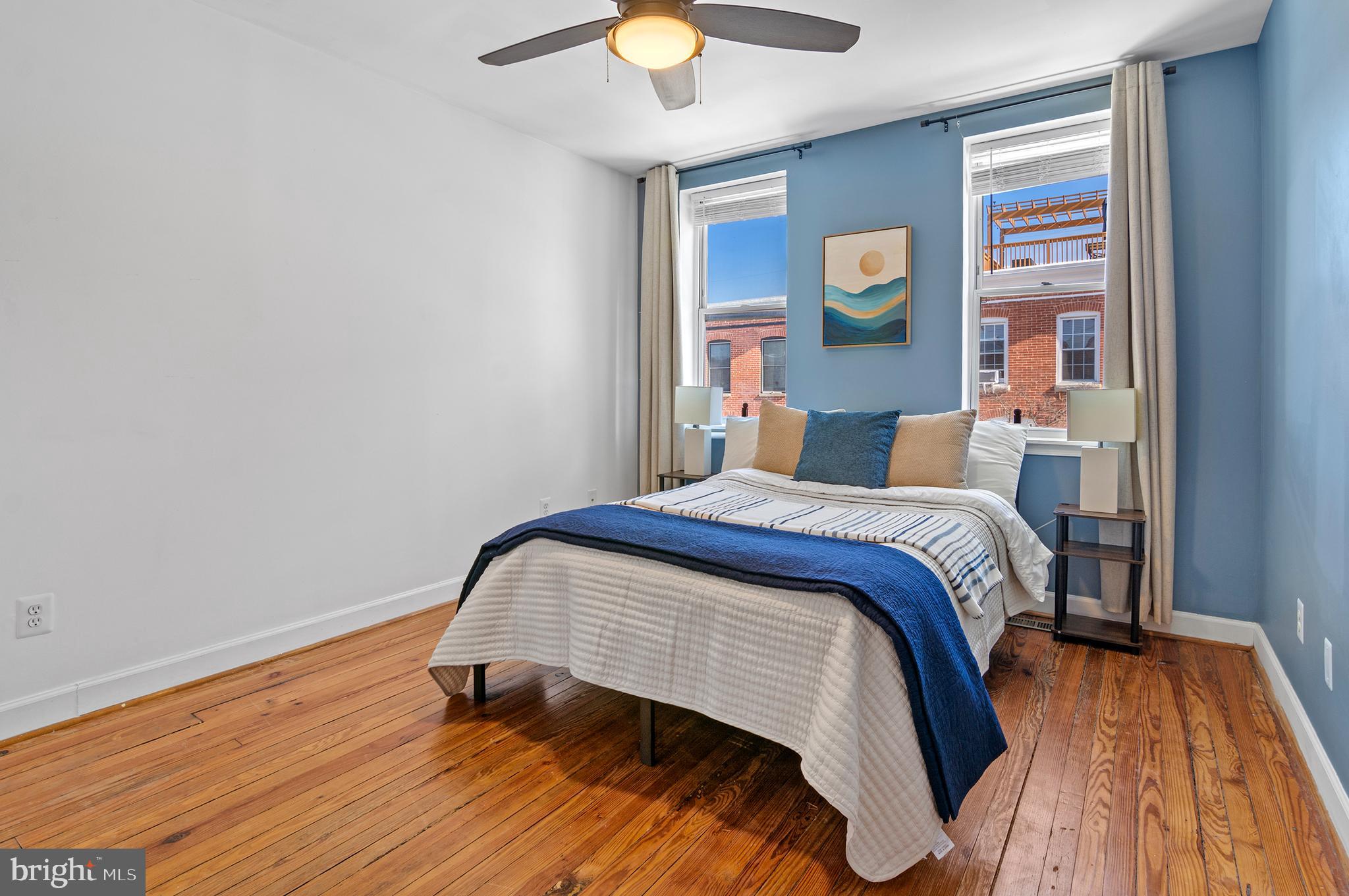 416 South Bouldin Street Baltimore, MD 21224 - Photo 30 of 45 a bedroom with a bed and lamp on table