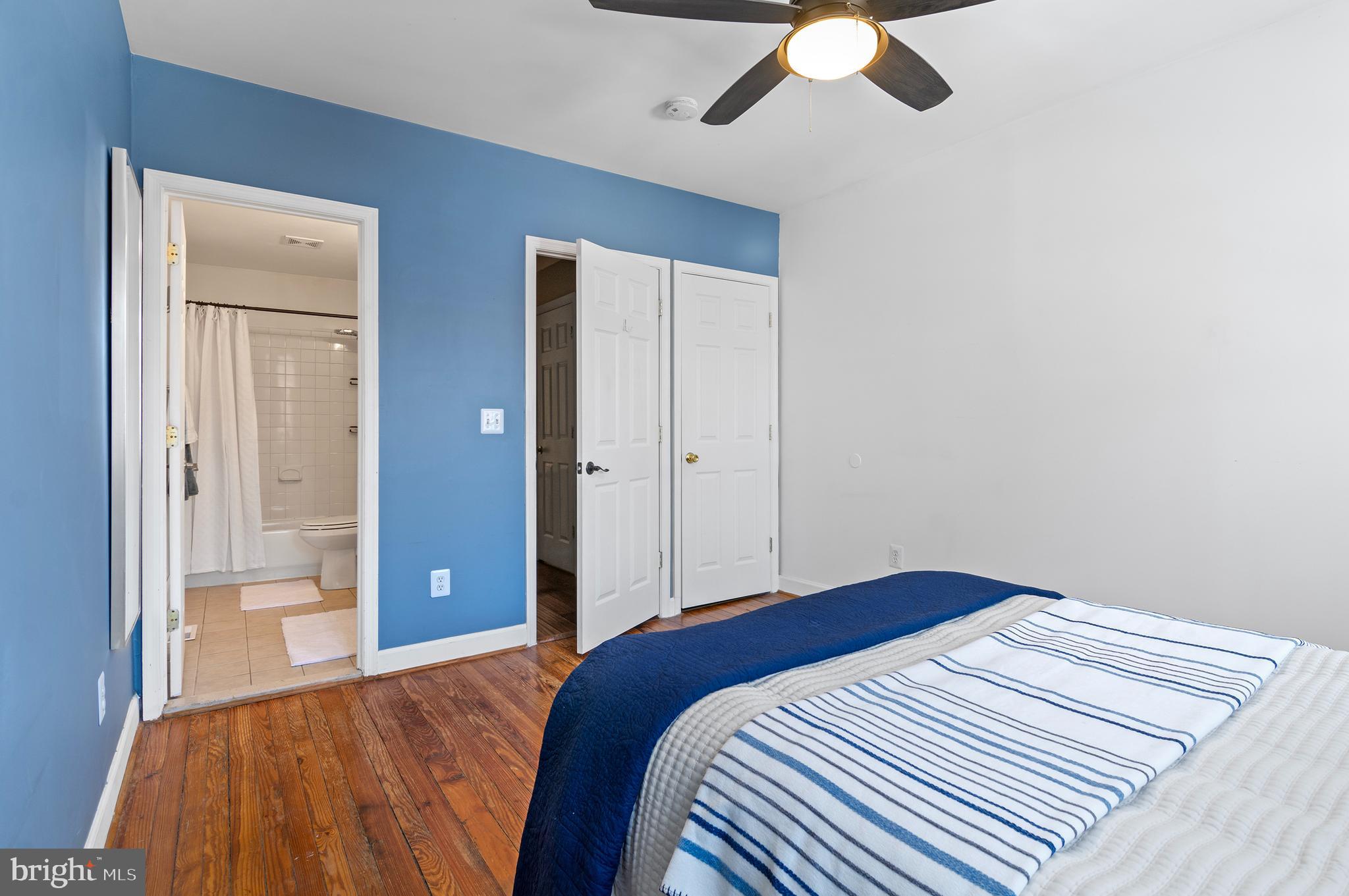 416 South Bouldin Street Baltimore, MD 21224 - Photo 32 of 45 a bedroom with a bed and a chandelier