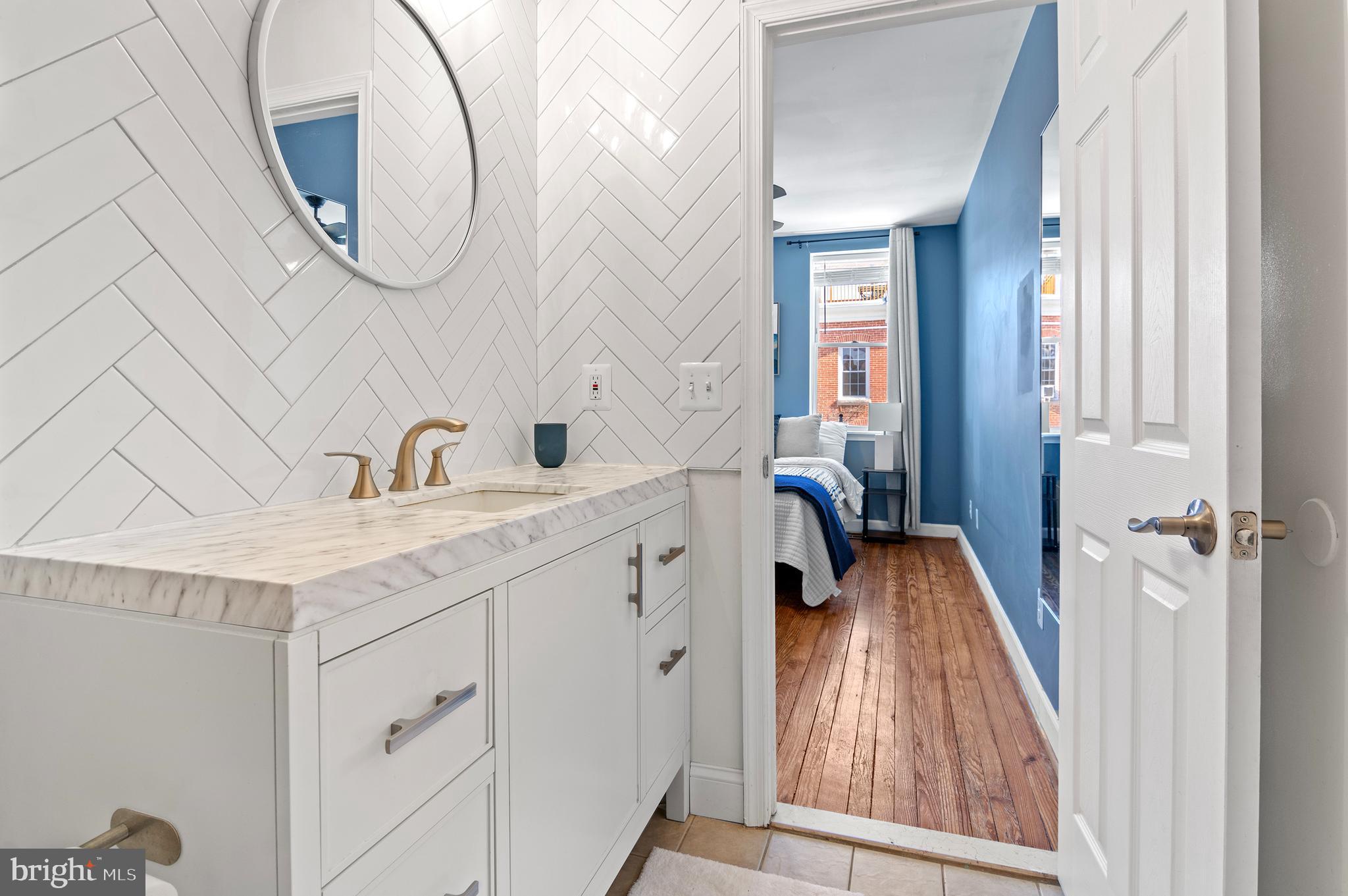 416 South Bouldin Street Baltimore, MD 21224 - Photo 34 of 45 a bedroom with a sink and a mirror