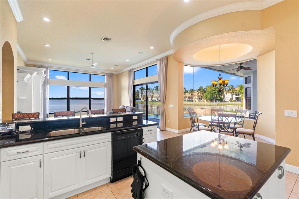18622 Southwest 41st Street Miramar, FL 33029 - Photo 12 of 63 a kitchen with stainless steel appliances granite countertop a sink a stove and a wooden cabinets