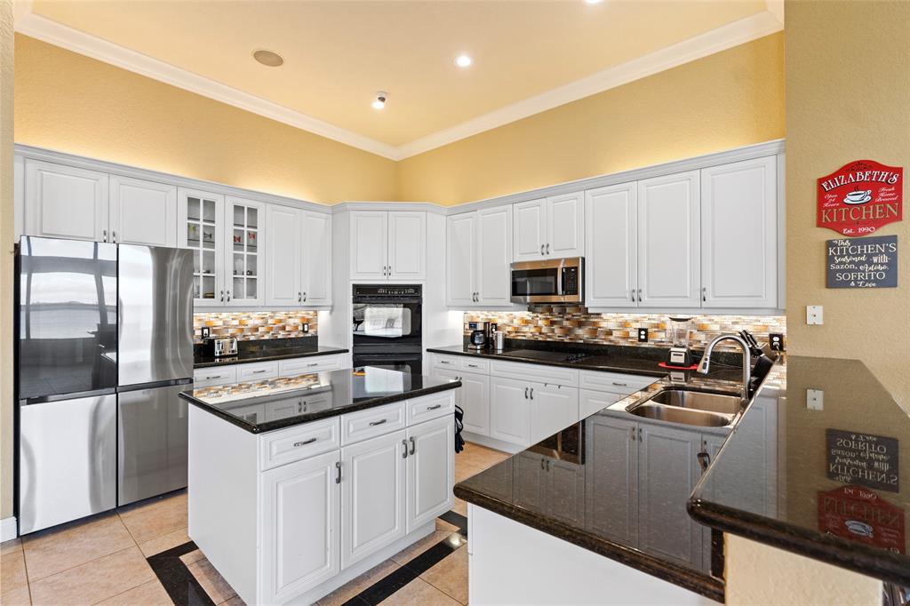 18622 Southwest 41st Street Miramar, FL 33029 - Photo 16 of 63 a kitchen with granite countertop a refrigerator stove and microwave