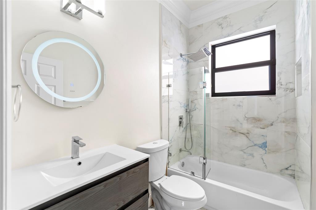 18622 Southwest 41st Street Miramar, FL 33029 - Photo 39 of 63 a bathroom with a sink a toilet and a mirror