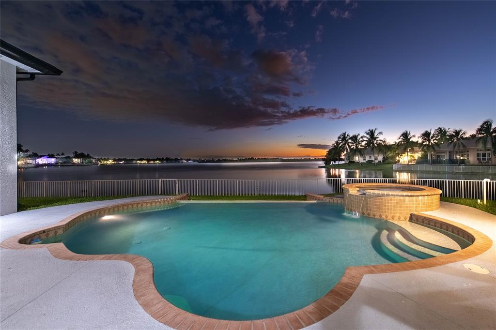 18622 Southwest 41st Street Miramar, FL 33029 - Photo 6 of 63 a view of a swimming pool with lake and houses in the back