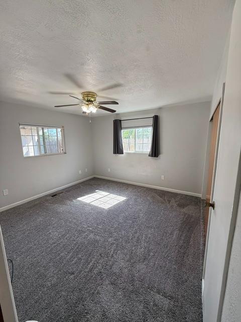 3019 Lathrop Road Manteca, CA 95336 - Photo 21 of 43 an empty room with windows and chandelier fan