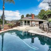 a view of a swimming pool with a patio