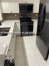 16520 Bridge End Road Miami Lakes, FL 33014 - Photo 4 of 20 a view of kitchen with a sink microwave and cabinets