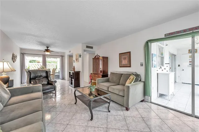 a dining room with furniture a chandelier and a rug