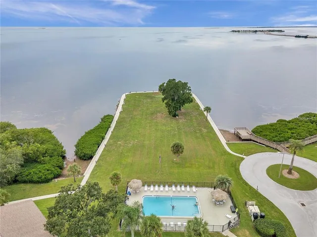 a view of a swimming pool with a yard