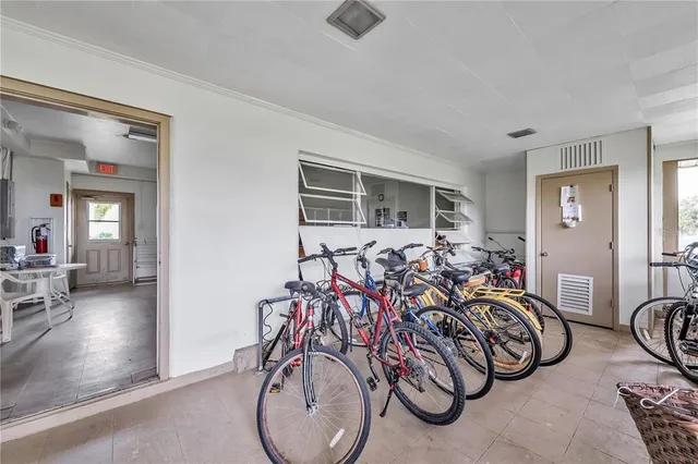 a room with pool table and windows
