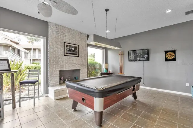 a living room with furniture and large windows