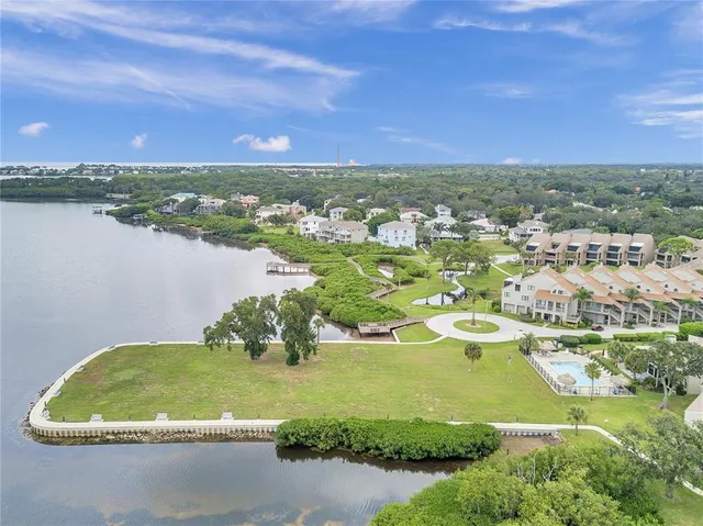 an aerial view of residential building with outdoor space and lake view