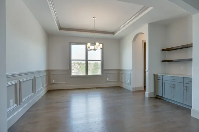 a view of a kitchen with a refrigerator and a sink