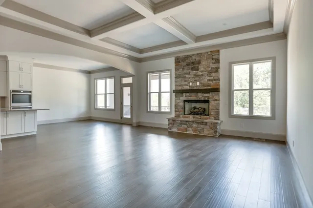 a view of a living room a fireplace and windows