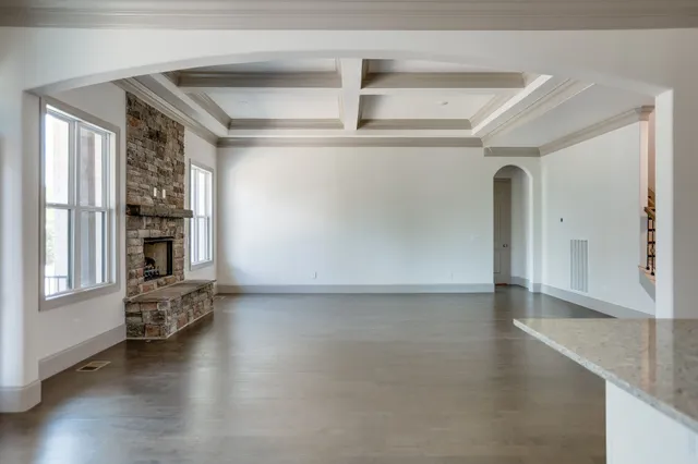 a kitchen with stainless steel appliances granite countertop a sink and cabinets with wooden floor