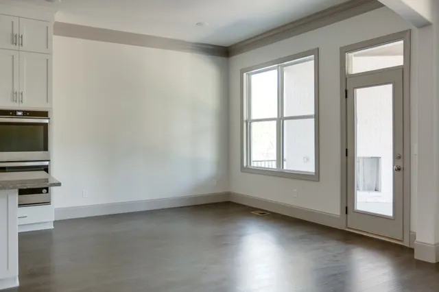 a view of a kitchen with a sink and refrigerator