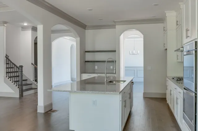a kitchen with a sink and a stove top oven