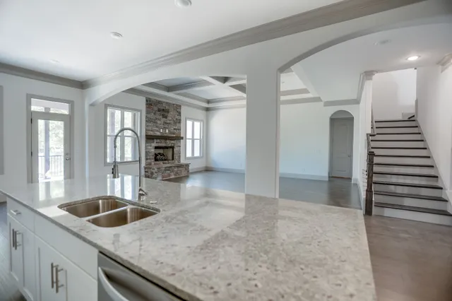 a bathroom with a sink a mirror and wooden floor