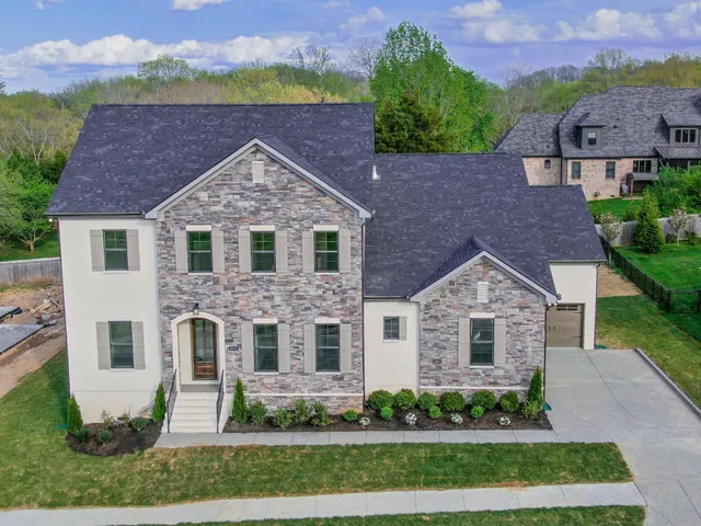 a front view of a house with a yard