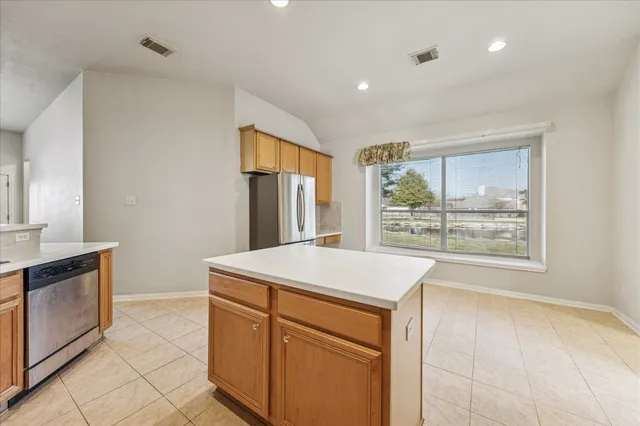 a kitchen with a stove a sink and a refrigerator