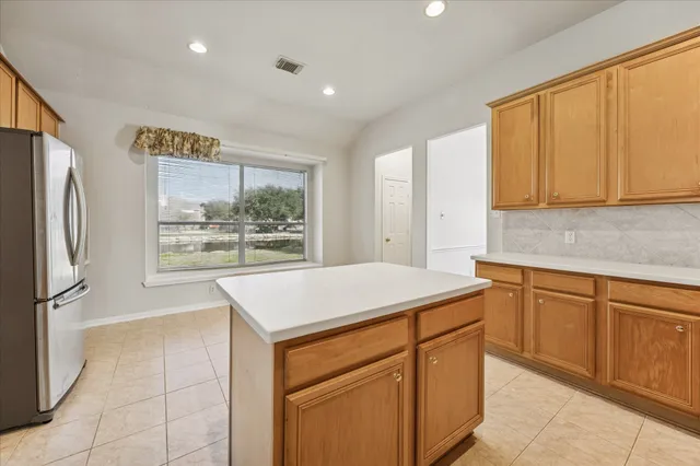 a kitchen with stainless steel appliances granite countertop a refrigerator sink and cabinets