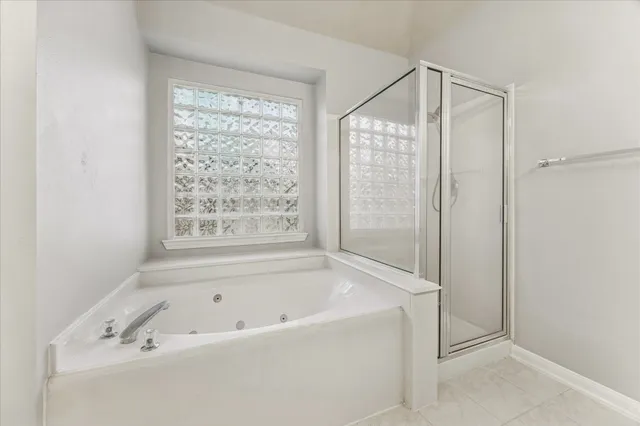 a bathroom with a bathtub and a shower
