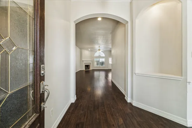 a view of a hallway with wooden floor