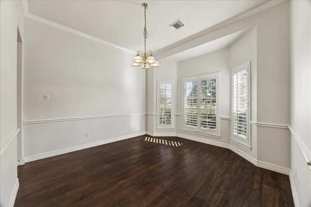 a view of a livingroom with wooden floor and a large window