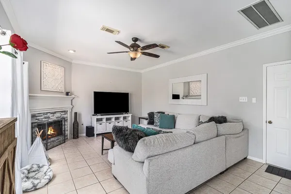 a view of a bedroom with wooden floor and ceiling fan
