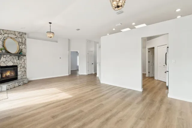 wooden floor in an empty room with a fireplace