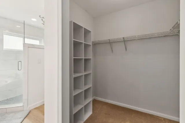 a view of walk in closet with empty racks