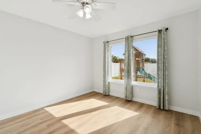 an empty room with windows and closet