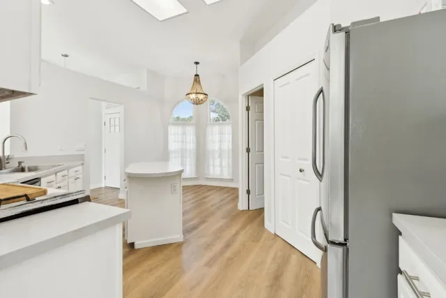 a kitchen with stainless steel appliances a refrigerator and a sink