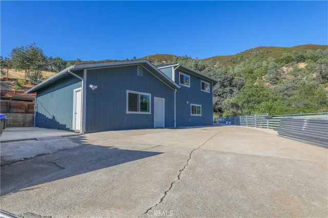 a view of a house with a yard and mountain