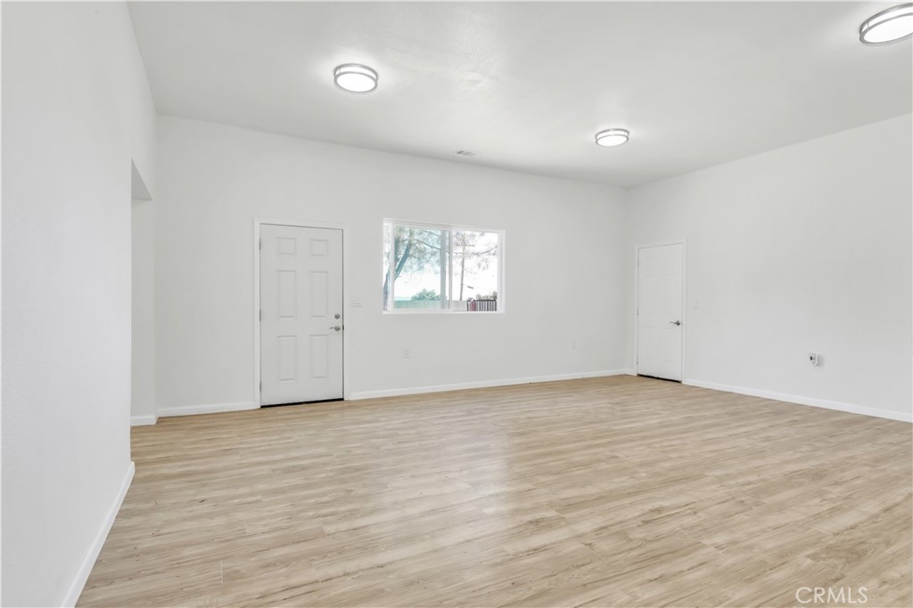 3273 Lee Street Nice, CA 95464 - Photo 22 of 50 a view of an empty room with wooden floor and window