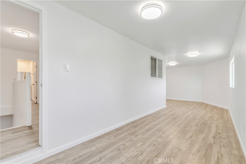 3273 Lee Street Nice, CA 95464 - Photo 29 of 50 an empty room with wooden floor and windows
