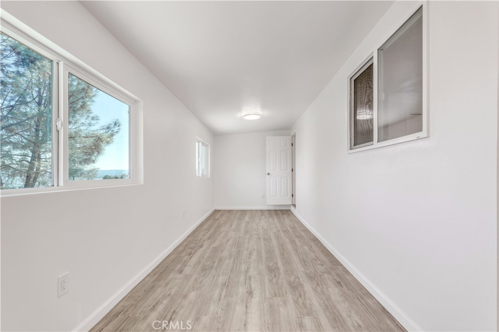 3273 Lee Street Nice, CA 95464 - Photo 31 of 50 a view of an empty room with wooden floor and a window