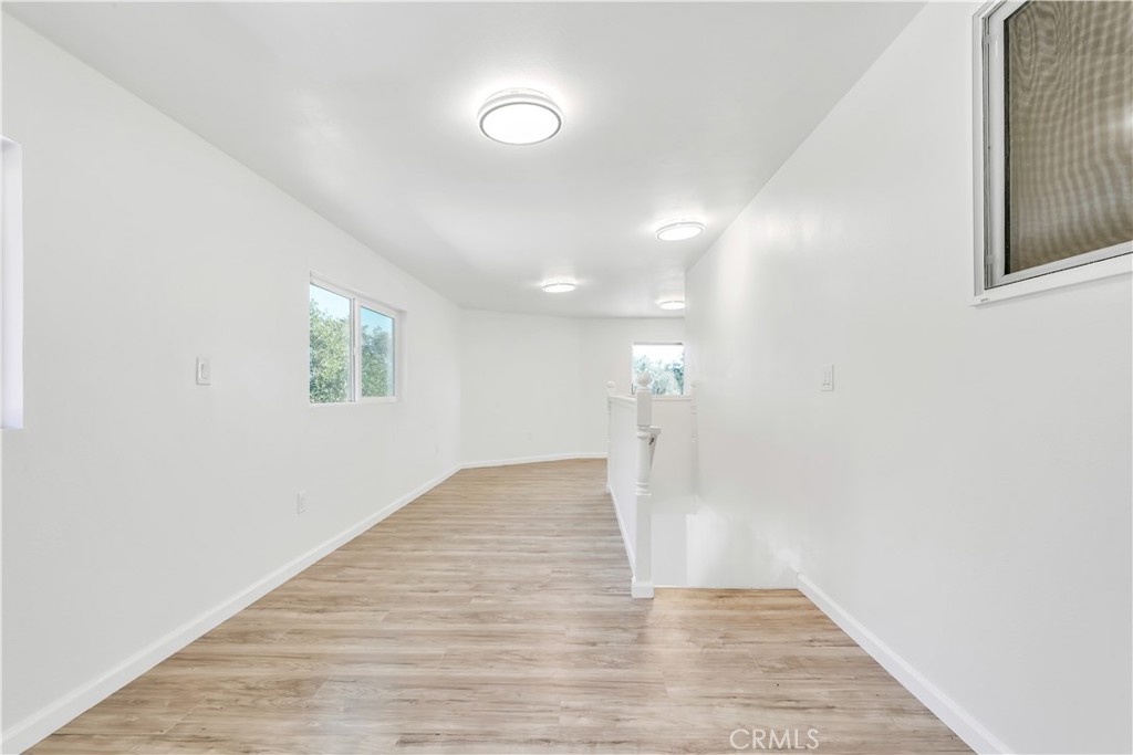 3273 Lee Street Nice, CA 95464 - Photo 33 of 50 an empty room with wooden floor and windows