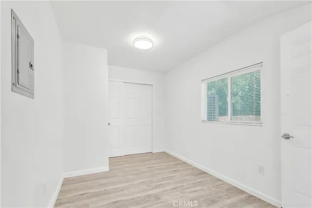 a view of empty room with wooden floor