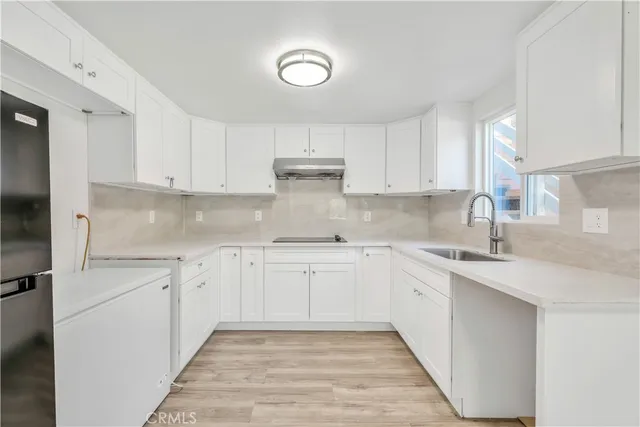 a kitchen with white cabinets and a sink