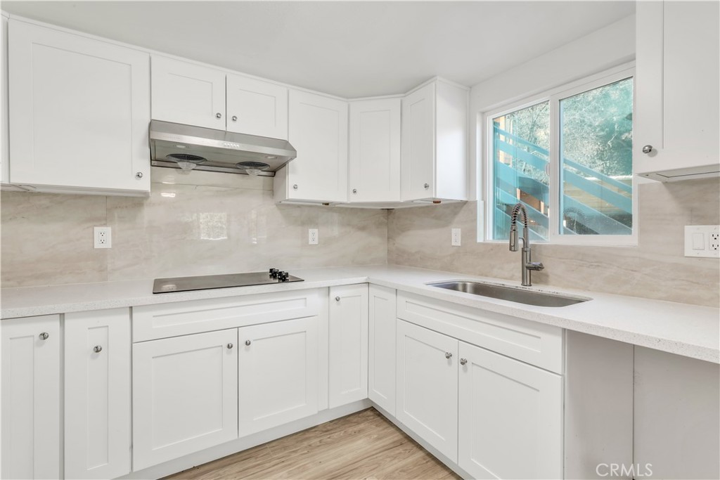 3273 Lee Street Nice, CA 95464 - Photo 37 of 50 a kitchen with white cabinets and a sink