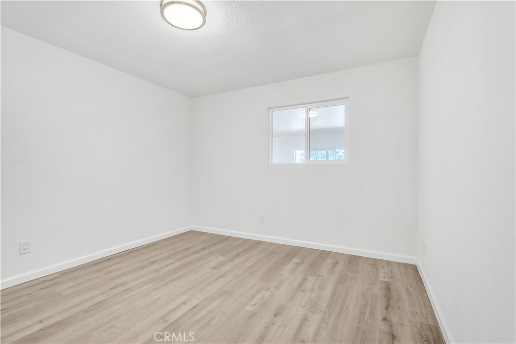 3273 Lee Street Nice, CA 95464 - Photo 48 of 50 an empty room with wooden floor and windows