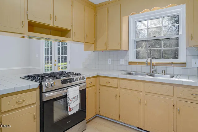 a kitchen with granite countertop cabinets stainless steel appliances and a sink