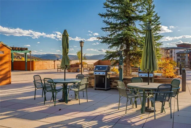 a view of a patio with table and chairs