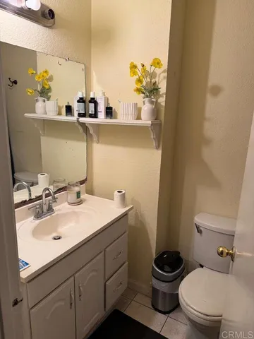 a bathroom with a sink a toilet and mirror