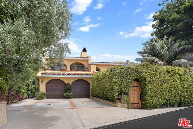 an aerial view of a house with yard and parking