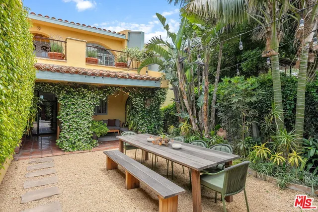 a view of a patio with table and chairs and potted plants