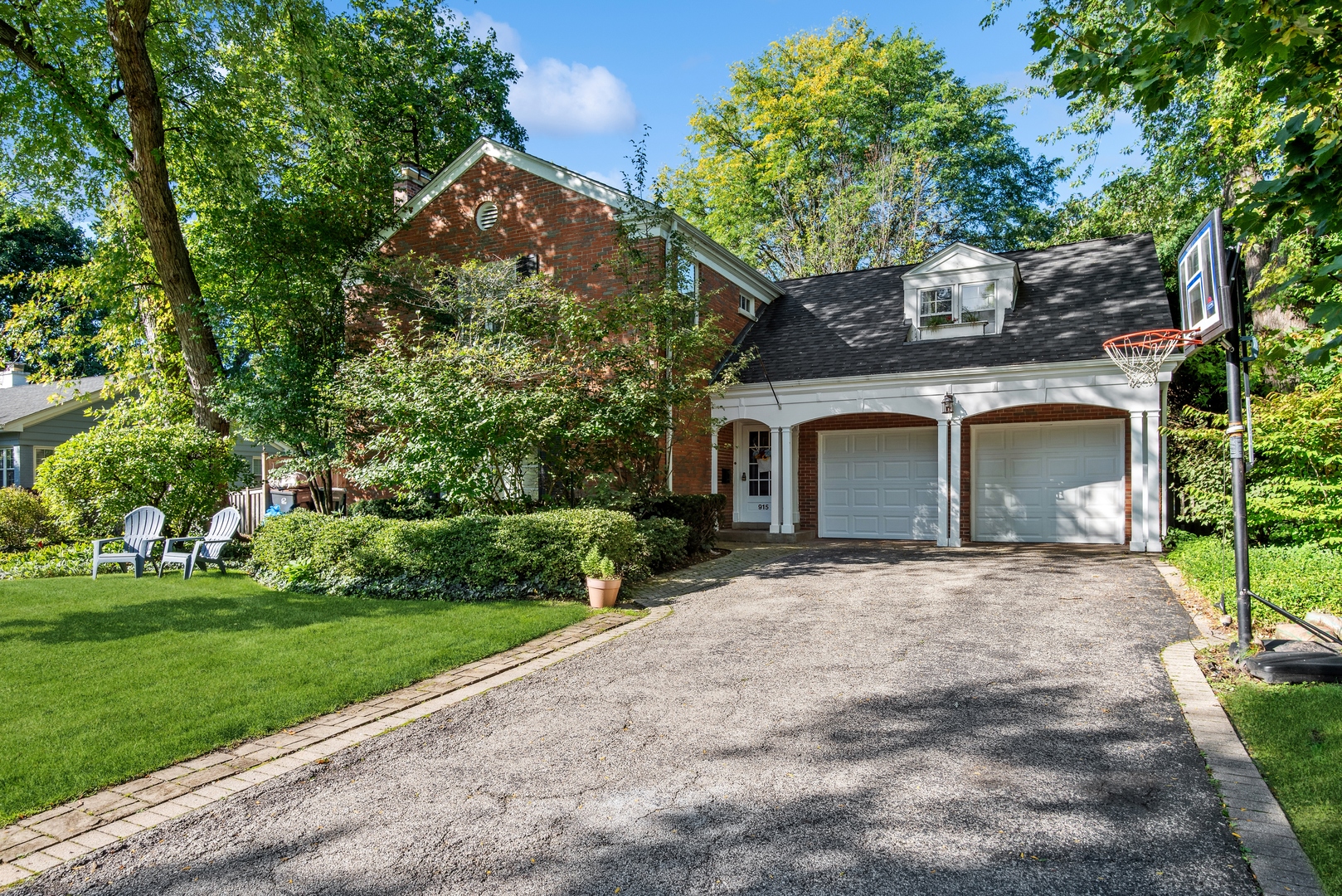 915 Pawnee Road Wilmette, IL 60091 - Photo 1 of 39 front view of a house with a garden