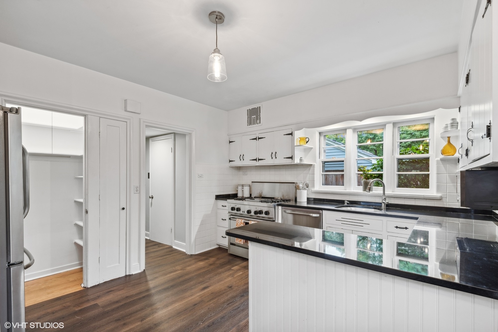 915 Pawnee Road Wilmette, IL 60091 - Photo 11 of 39 a kitchen with stainless steel appliances a sink a stove and a window
