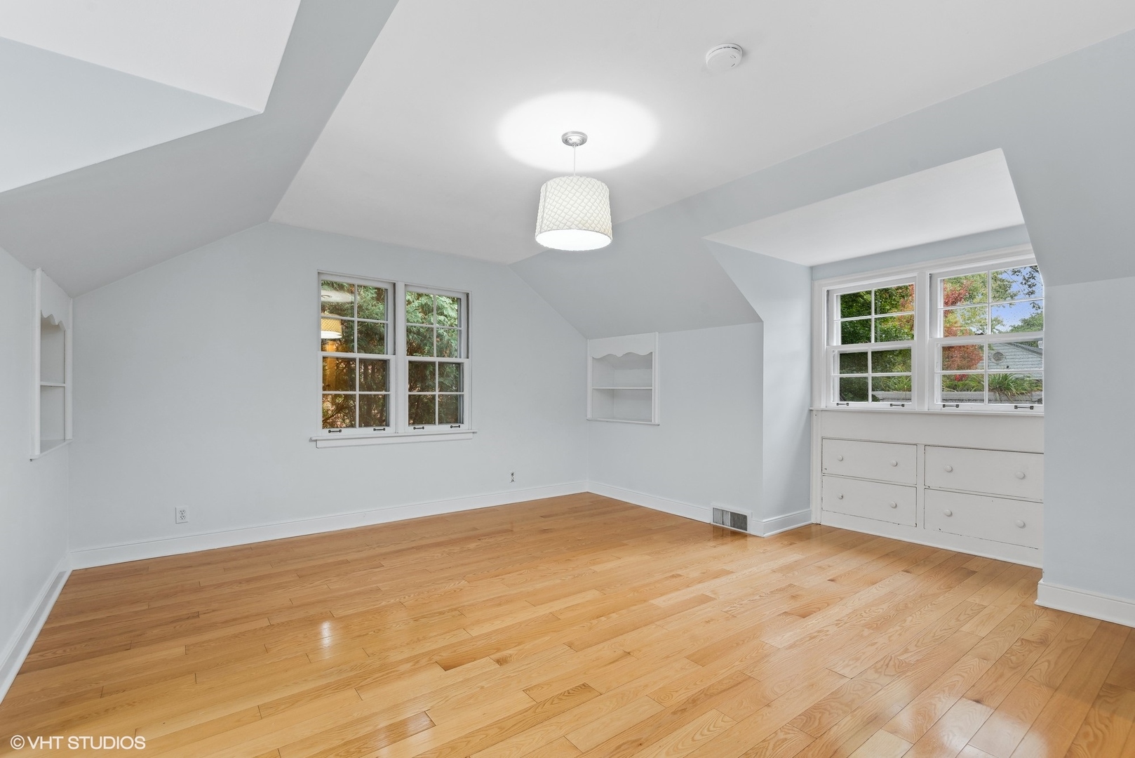 915 Pawnee Road Wilmette, IL 60091 - Photo 19 of 39 a view of empty room with wooden floor and windows